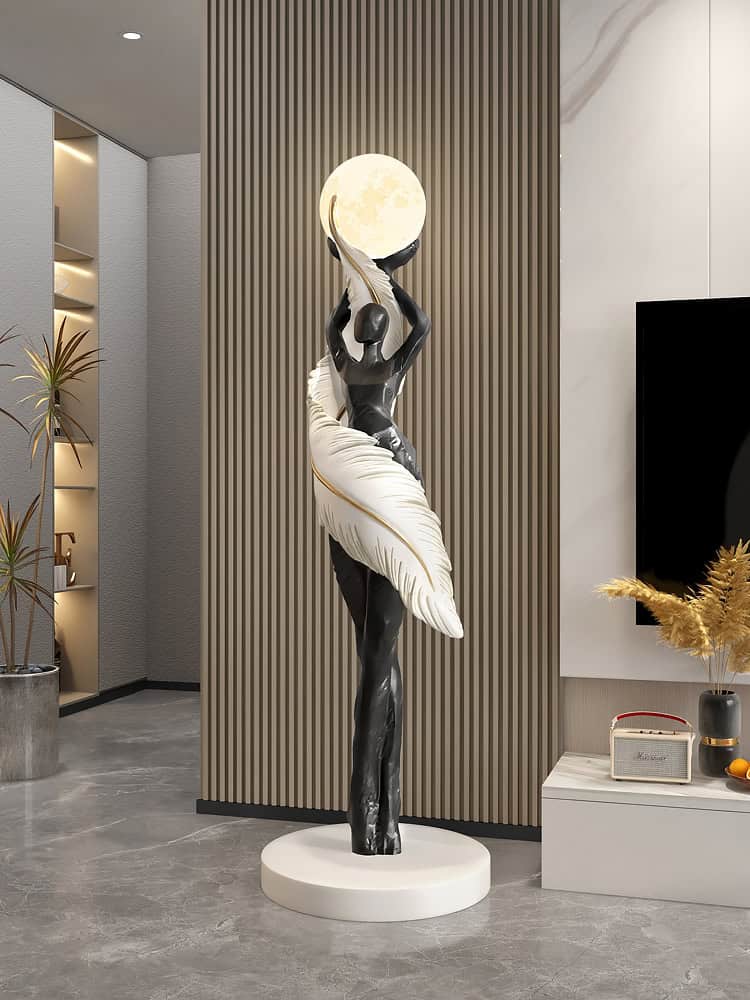 Elegant modern sculpture of a woman holding a luminous moon, decorative art piece at Monalisa Store with contemporary interior design elements in the background.