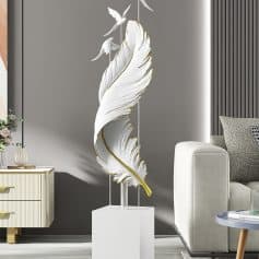 Elegant white feather sculpture with gold accents and flying bird details at Monalisa Medical Store, showcasing stylish modern decor for wellness and healthcare environments.