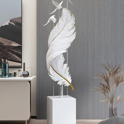 Elegant white sculpture featuring flying birds and a large feather, ideal for modern home or office decor, offering artistic and stylish ambiance.