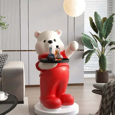 Vibrant teddy bear statue holding a tray of colorful bottles in modern interior, perfect for home decor, children's room, or themed space with a playful and artistic touch.