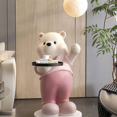 Cute bear statue holding a tray with a coffee cup at Monalisa Medical Store, modern interior design, decorative art piece, inviting atmosphere for healthcare and wellness products, eye-catching display.