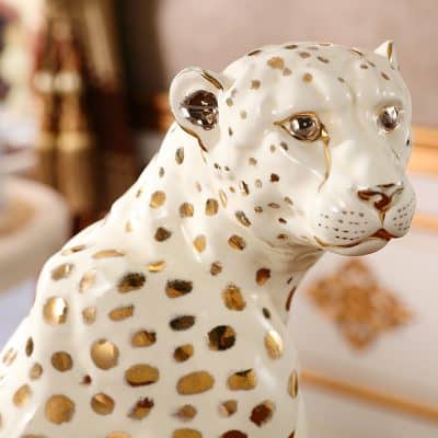 Sleek decorative ceramic leopard figurine with gold accents, perfect for luxury home decor and stylish interior design.