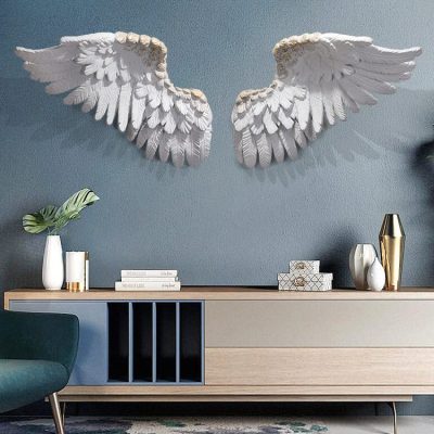 Elegant angel wing wall decor art in living room with modern console table and decorative vases, perfect for enhancing interior design with unique wall sculptures.