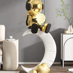 Astronaut sitting on a moon-shaped sculpture, holding a glowing moon lamp, in a modern interior space with minimalist decor, representing innovative lighting and home decor customization.