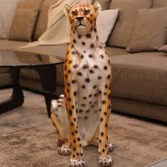 Stunning cheetah-shaped sculpture in living room, decorative animal art piece, enhances home decor with exotic wildlife motif, perfect for animal lovers, high-quality craftsmanship.