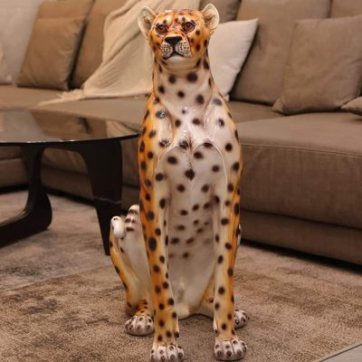 Stunning cheetah-shaped sculpture in living room, decorative animal art piece, enhances home decor with exotic wildlife motif, perfect for animal lovers, high-quality craftsmanship.