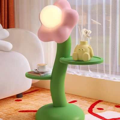 Colorful cloud-shaped LED night lamp and decorative items on a green tree-shaped side table in a modern, cozy bedroom. Perfect for home decor, ambient lighting, and creating a playful atmosphere in your space.