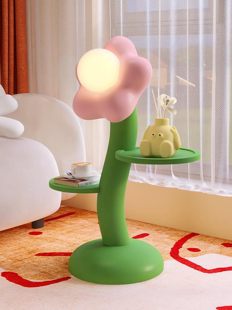 Colorful cloud-shaped LED night lamp and decorative items on a green tree-shaped side table in a modern, cozy bedroom. Perfect for home decor, ambient lighting, and creating a playful atmosphere in your space.