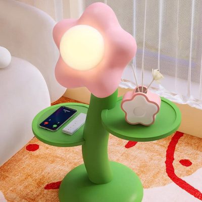 Flower-shaped LED desk lamp in pink and green with a moon-shaped storage container, perfect for modern bedroom decor and a cozy reading nook, emphasizing aesthetics and functionality in a child's or teen's room, ideal for enhancing any bedroom's ambiance.