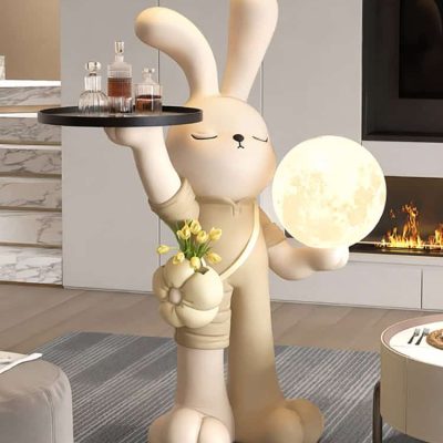 Cute bunny decorative lamp holding a moon replica and a tray of perfumes, stylish home decor emphasizing modern, playful aesthetics with a touch of luxury, ideal for a sophisticated interior design.