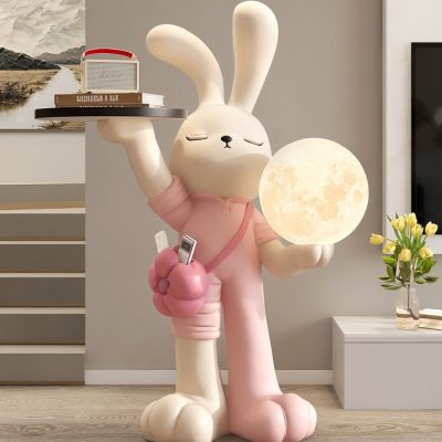 Whimsical bunny sculpture holding a moon lamp in a modern interior, with shelves and flowers, creating a playful and cozy aesthetic. Perfect for home decor and nursery spaces.