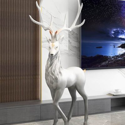 Antlered deer sculpture, modern home decor, white decorative reindeer, stylish interior design, luxury living room accessory.
