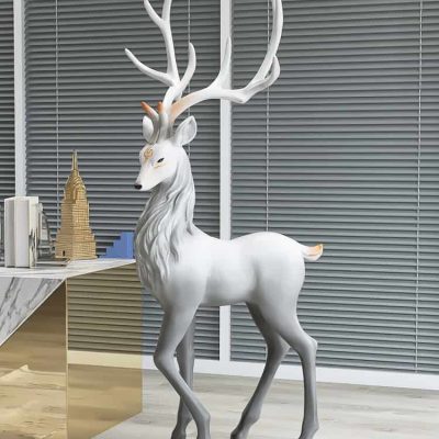 White decorative reindeer sculpture with antlers in modern office space, ideal for holiday decor or luxury interior design, enhancing aesthetic appeal.