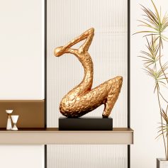 Golden swan sculpture decor at Monalisa Store, enhancing modern optical and eyewear boutique interior design with elegant art pieces.