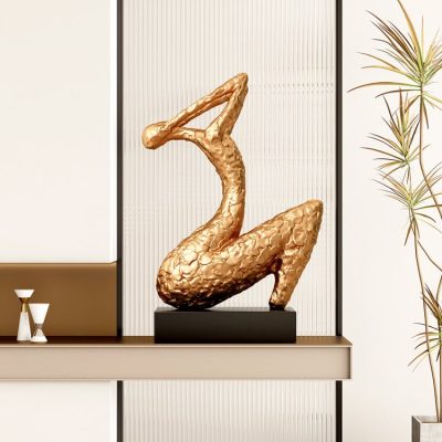 Golden swan sculpture decor at Monalisa Store, enhancing modern optical and eyewear boutique interior design with elegant art pieces.