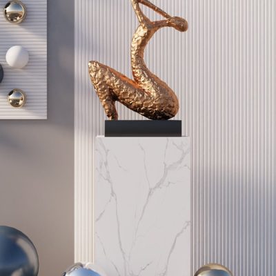 Elegant golden sculpture displayed on a white marble pedestal, modern interior decor, perfect for luxury art collections or interior design accents.