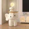 Elephant-shaped lamp with a moon and bunny decor on top, stylish and whimsical interior lighting piece for modern home decor.
