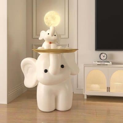 Elephant-shaped lamp with a moon and bunny decor on top, stylish and whimsical interior lighting piece for modern home decor.