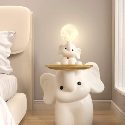 Whimsical elephant-themed nightlight with a cute elephant lamp featuring a moon-shaped light on a gold tray, perfect for children's rooms and bedroom decor.