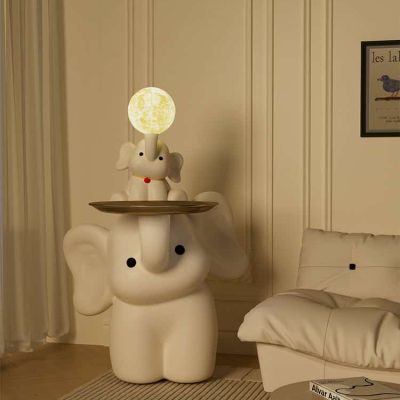 Whimsical elephant lamp with a moonlit glowing head, decorative elephant design in a cozy room setting. Perfect for children's rooms or playful interior decor.