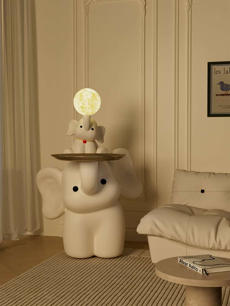 Whimsical elephant lamp with a moonlit glowing head, decorative elephant design in a cozy room setting. Perfect for children's rooms or playful interior decor.