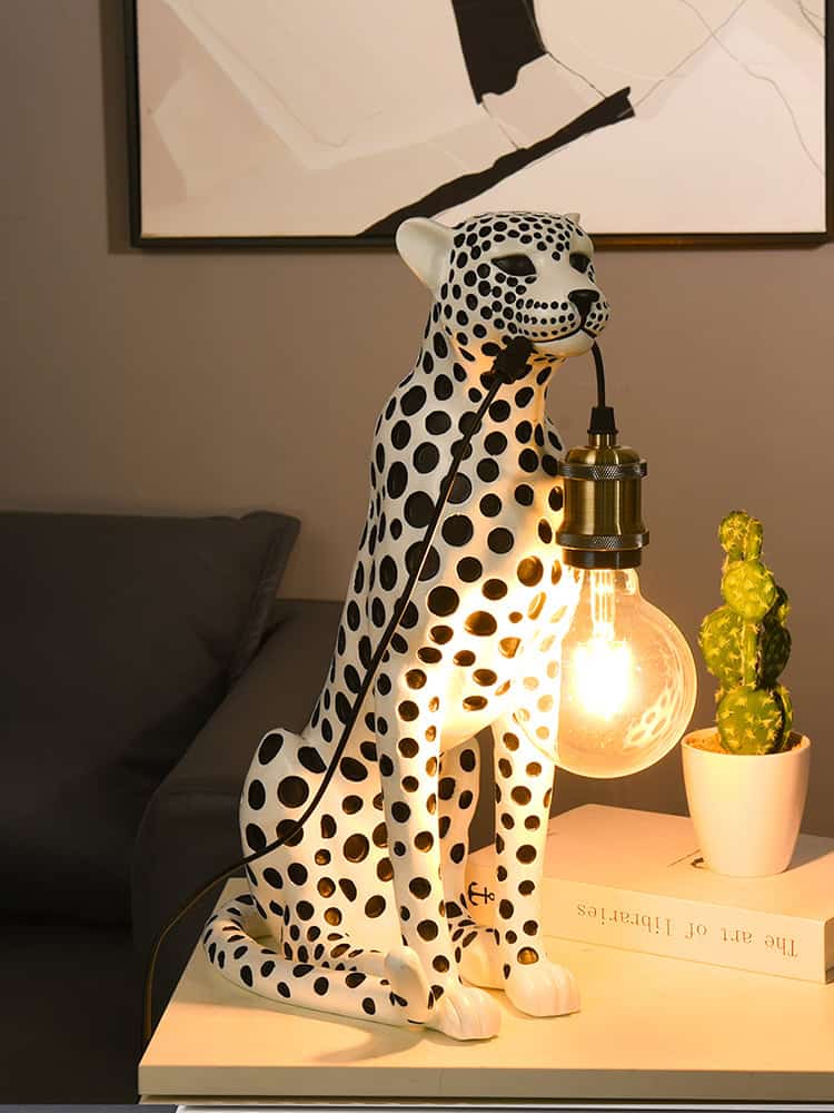 Polka dot leopard table lamp with warm glowing light, modern home decor for living room or bedroom. Unique animal-shaped lighting fixture showcasing contemporary interior design.