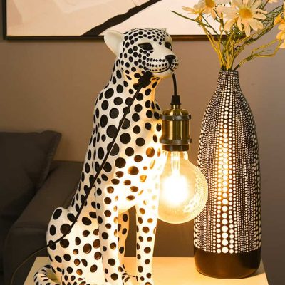 Artificial cheetah lamp with lightbulb and decorative vase with flowers, modern home decor, Monalisa Store, stylish interior design accessory, contemporary lighting solution, unique accent piece, trendy decor item for living room, eye-catching centerpiece, elegant decorative lamp, artistic home styling, home lighting innovation, decorative cheetah figurine lamp, chic room decoration, ambient lighting fixture.