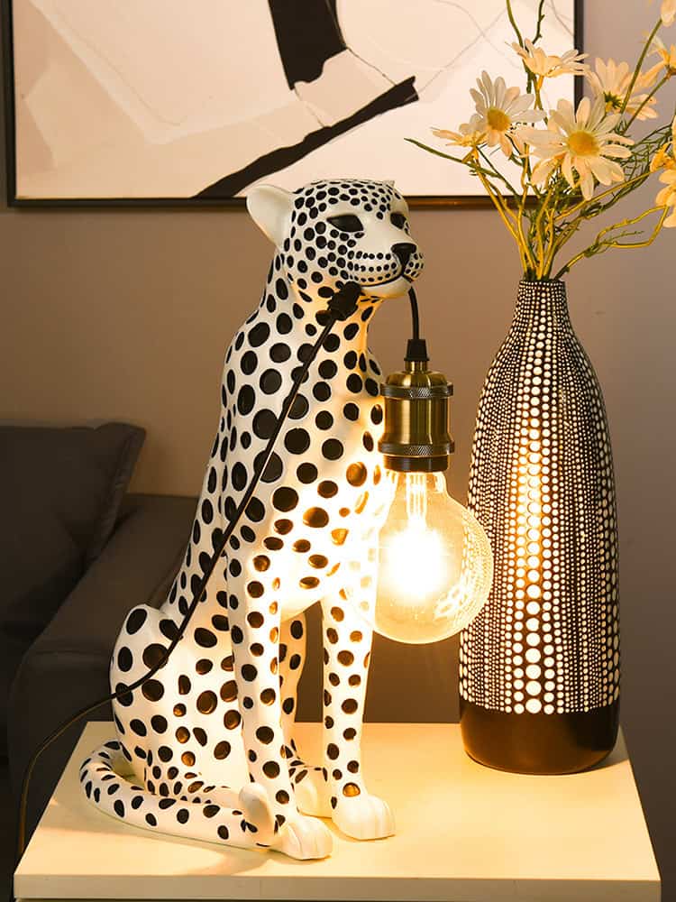Artificial cheetah lamp with lightbulb and decorative vase with flowers, modern home decor, Monalisa Store, stylish interior design accessory, contemporary lighting solution, unique accent piece, trendy decor item for living room, eye-catching centerpiece, elegant decorative lamp, artistic home styling, home lighting innovation, decorative cheetah figurine lamp, chic room decoration, ambient lighting fixture.