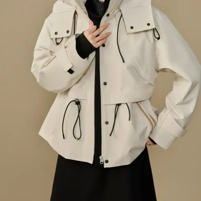 Functional waterproof white jacket with adjustable drawstrings, multiple pockets, and modern design. Perfect for outdoor activities and stylish everyday wear.