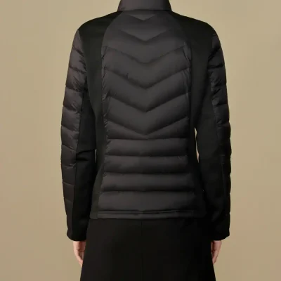 Versatile black puffer jacket with sleek design, perfect for fall and winter, stylishly paired with a black skirt, ideal for casual and semi-formal occasions, high-quality material for warmth and comfort.