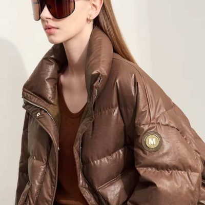 Oversized brown leather puffer jacket with logo patch, stylish sunglasses, and fashionable outfit on female model, perfect for luxury outerwear shopping at Monalisa Store.