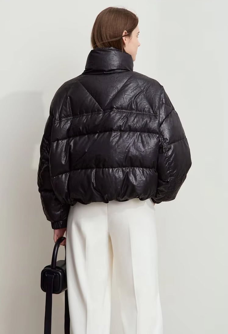 Stylish black puffer jacket with high collar, perfect for cold weather, showcased at Monalisa Store for trendy winter fashion.