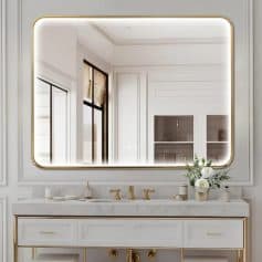 Luxurious white bathroom vanity with gold accents and large illuminated mirror in elegant modern interior. Perfect for high-end spa or optometry spa setting, emphasizing sophistication and style in eye care spaces.