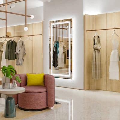 Elegant display of women's fashion and eyewear boutique with a stylish mirror for trying on glasses, modern decor, and comfortable seating, perfect for an optometry or optical retail store.