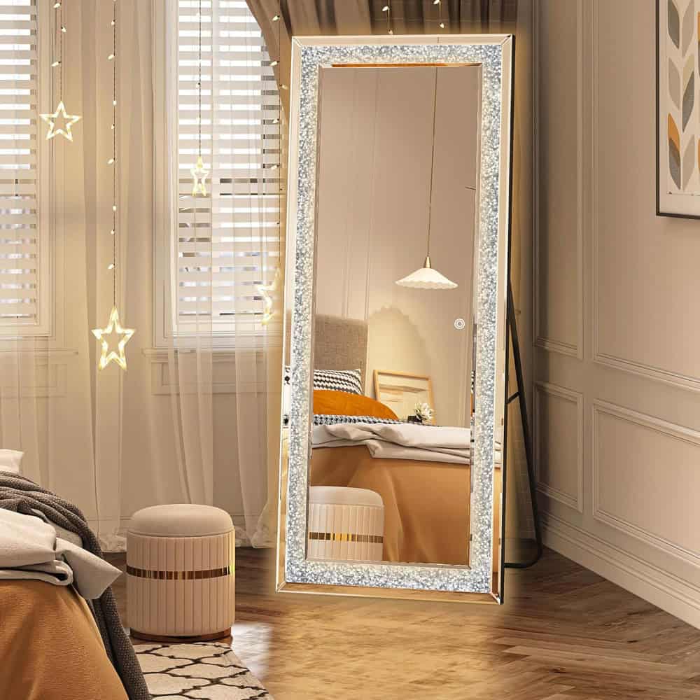 Bright full-length mirror with illuminated glitter frame in cozy bedroom interior. Perfect for vanity and dressing rooms, enhancing space with elegant decor. Ideal for home or retail interiors.