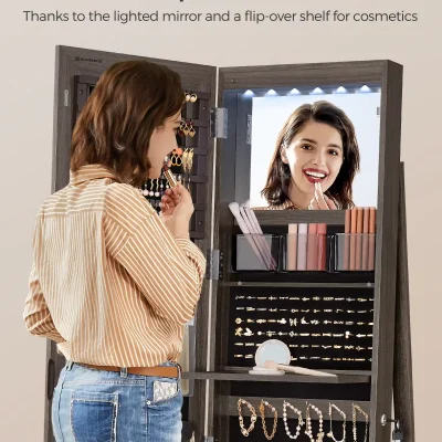Polished makeup mirror with LED lights and jewelry storage in modern vanity, woman applying lipstick, beauty accessories organized in a stylish makeup station, Monalisa store cosmetics and beauty products, product display and personal grooming station for makeup lovers.