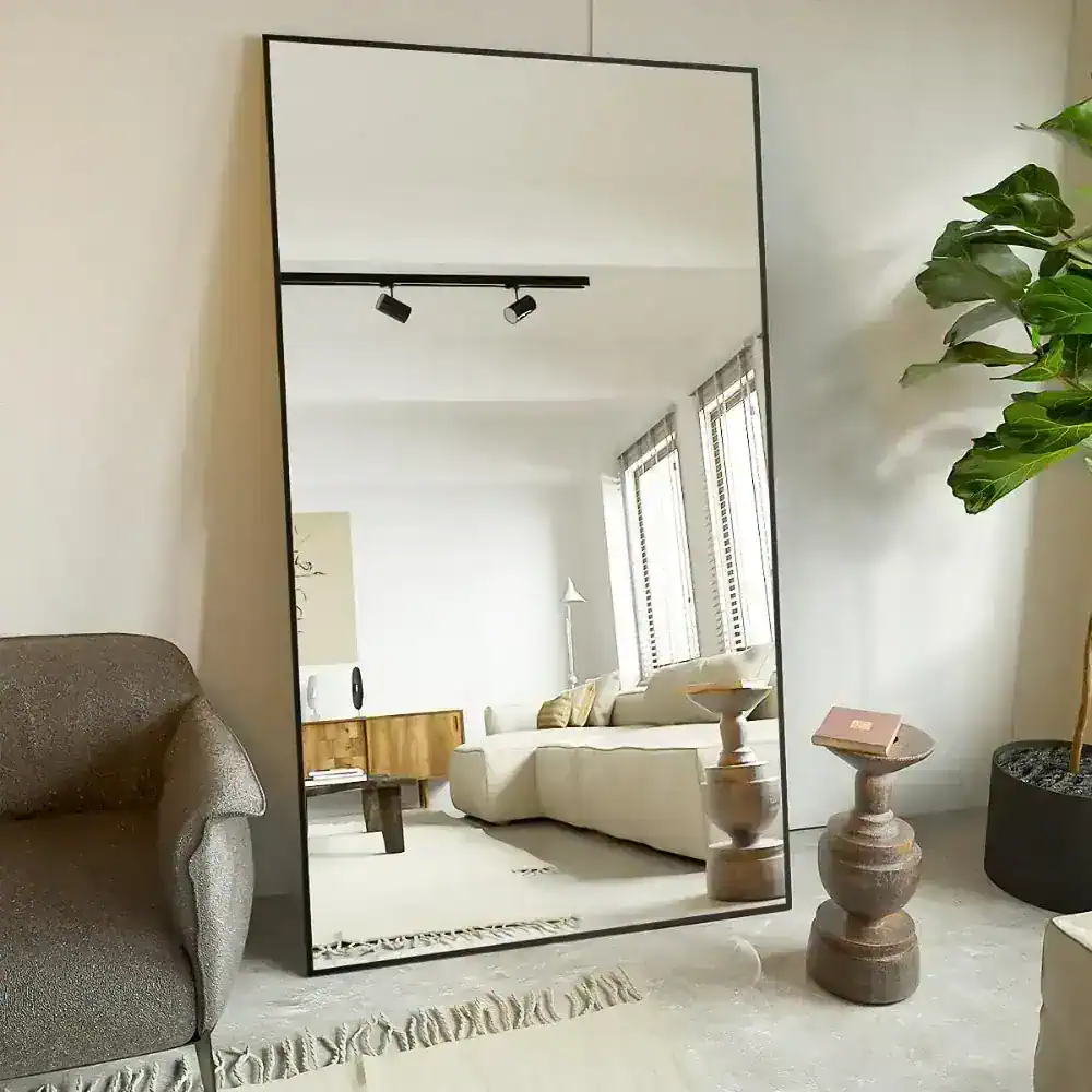 Large full-length mirror in modern living room with natural light, cozy seating, and contemporary decor, suitable for home or boutique retail spaces.