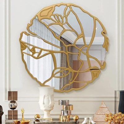 Gold geometric decorative wall mirror with an abstract face design, modern interior home decor, luxe living room accent, Monalisa Store, fashionable wall art centerpiece, luxury mirror with gold frame, stylish interior decor element, contemporary art piece for elegant spaces.