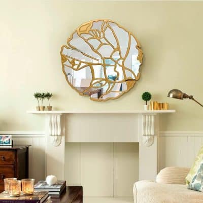 Reflective wall mirror with intricate gold leaf design, stylish living room decor, enhancing space with elegant modern aesthetics.