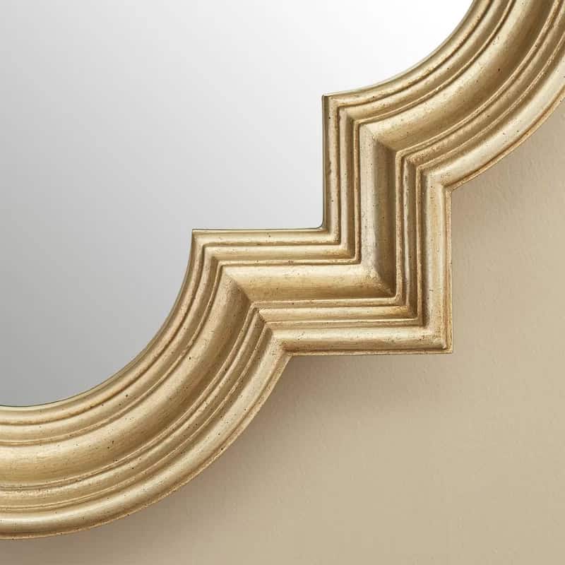 Intricate gold-leaf framed mirror with vintage decorative detailing, perfect for enhancing elegance in optometry and eyewear spaces.