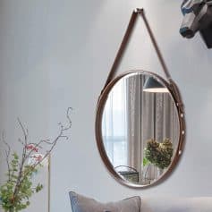 Round wall mirror with leather strap accent, stylish interior decor at Monalisa Store.