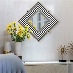 Vibrant yellow flowers in a modern living room with black and white geometric mirror decor, stylish accessories, and elegant neutral furnishings.