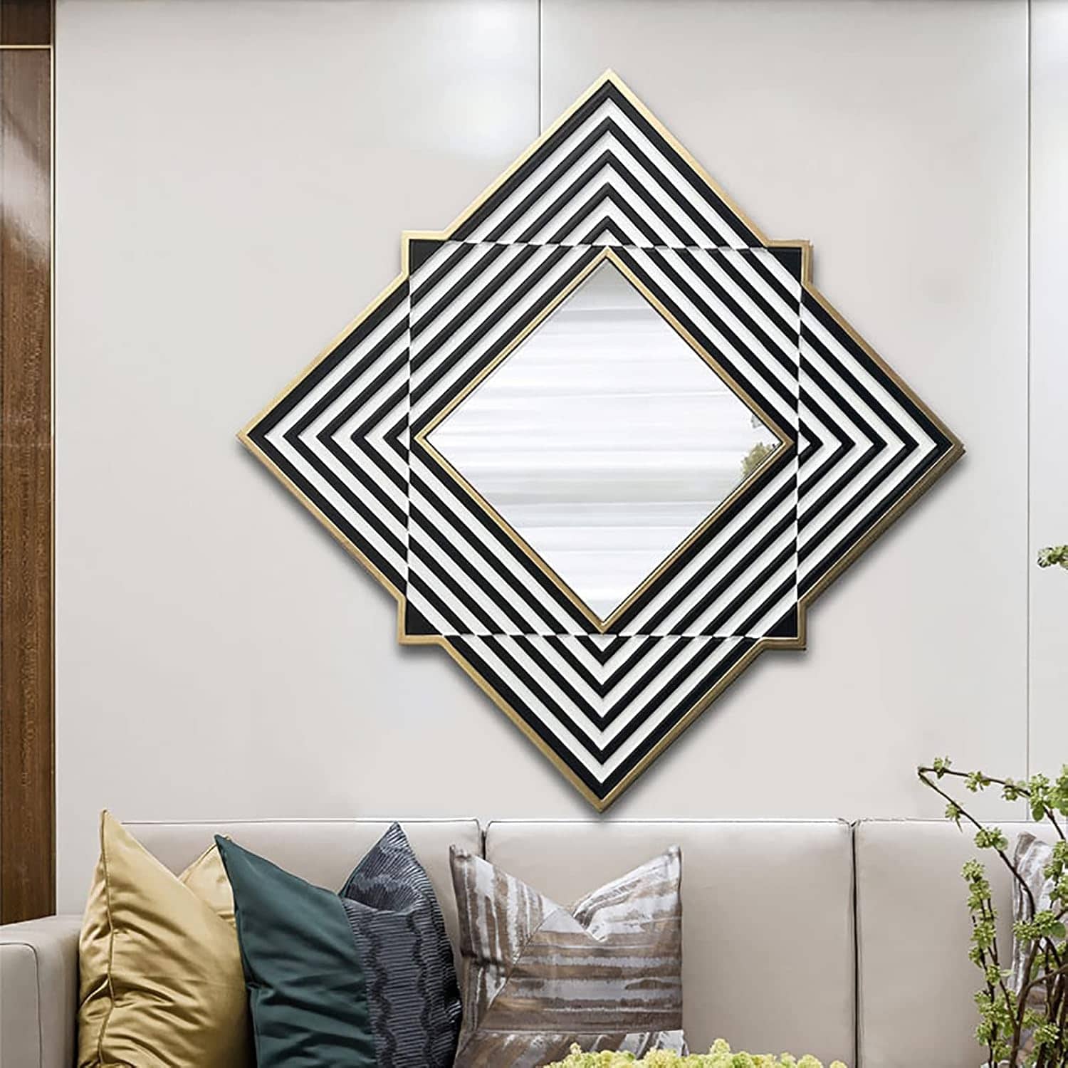 Contemporary geometric wall mirror with black, white, and gold accents in a modern living room. Stylish decor and sophisticated design enhance the space's aesthetic appeal.