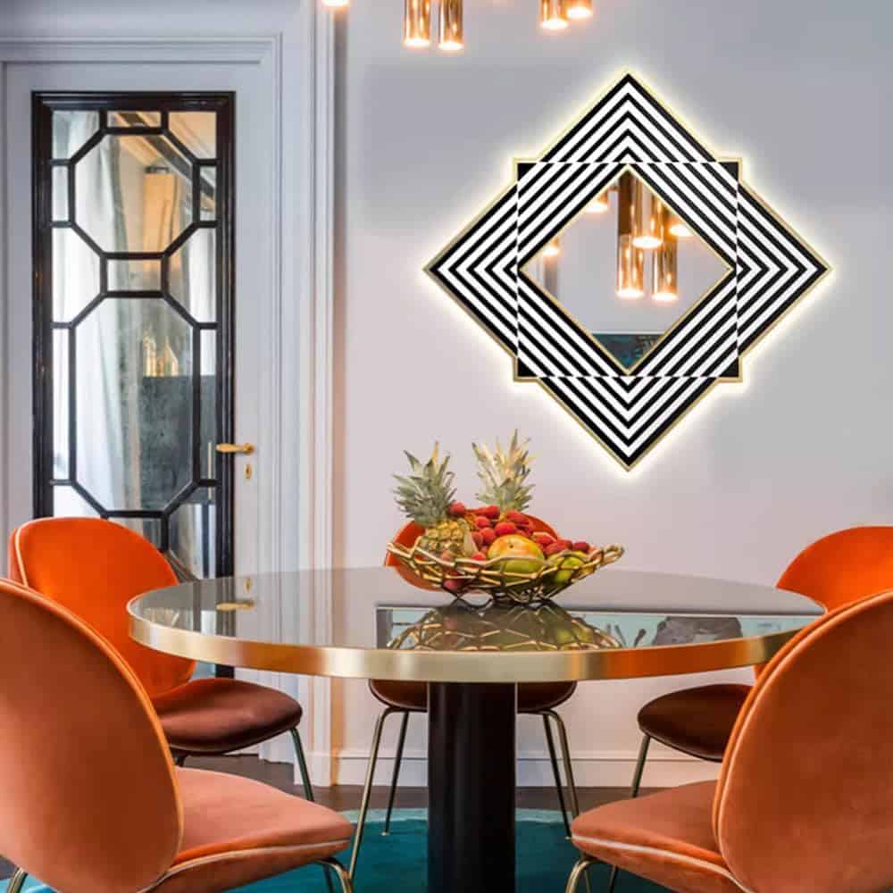 Bright modern dining area featuring stylish geometric wall mirror and chic orange velvet chairs, perfect for a contemporary Monalisa Store opt space.