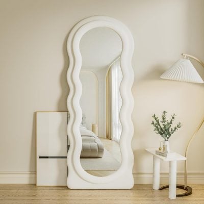 Wavy-edge white framed full-length mirror in a stylish, modern bedroom with neutral tones and minimalist decor, ideal for home or professional optometry clinic settings.