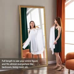 Elegant woman trying on white blouse in front of full-length mirror at Monalisa Store for optical eyewear and accessories shopping.