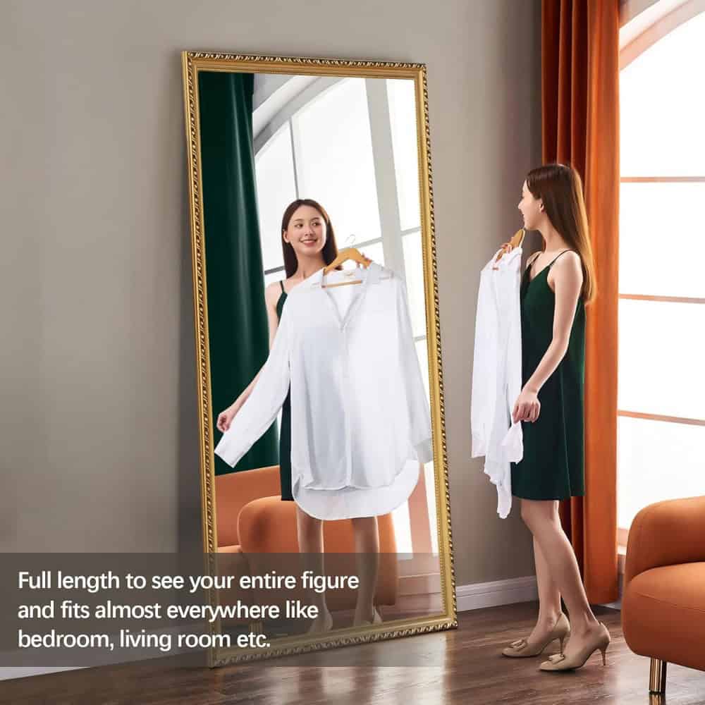Elegant woman trying on white blouse in front of full-length mirror at Monalisa Store for optical eyewear and accessories shopping.
