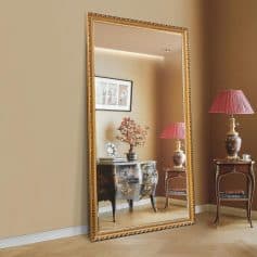 Elegant full-length mirror with gold decorative frame reflecting antique-style furniture and floral lamps, ideal for enhancing luxury and classic aesthetic in interior decor.