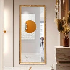 Sophisticated full-length gold-framed mirror at Monalisa Store, featuring modern decor with elegant accents and stylish floral arrangements, perfect for dressing rooms and interior design enthusiasts.