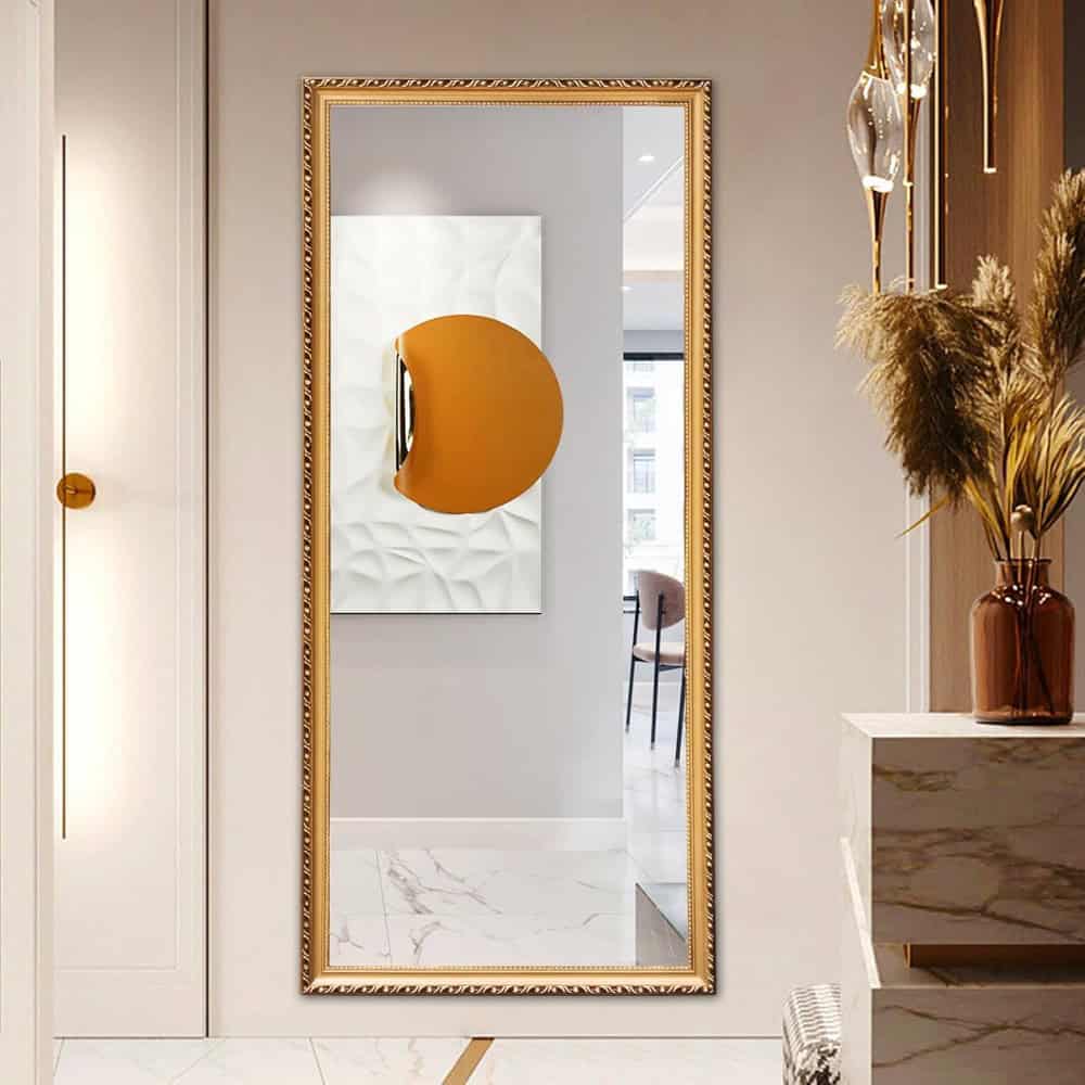 Sophisticated full-length gold-framed mirror at Monalisa Store, featuring modern decor with elegant accents and stylish floral arrangements, perfect for dressing rooms and interior design enthusiasts.